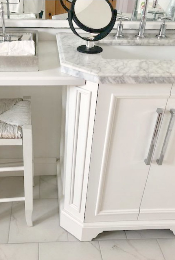 Classic white traditional bathroom design with carrara topped vanity and Kohler Purist bathroom faucet - Hello Lovely Studio.