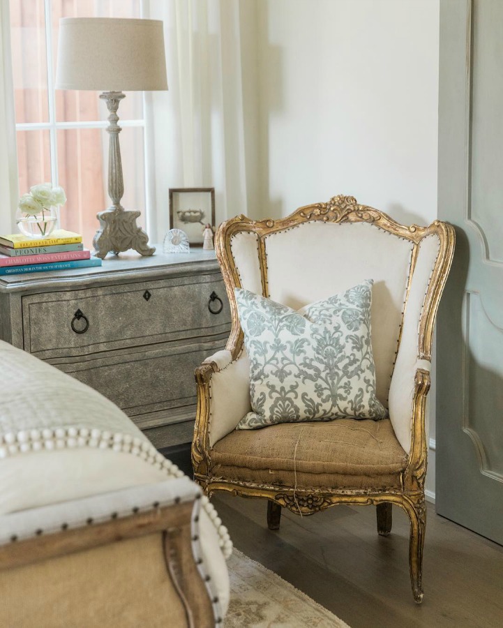Wingback French chair French country farmhouse white bedroom. Sherwin Williams Alabaster paint color on walls. Brit Jones Design. See 18 Inspiring Country French Bedroom Decor Ideas!