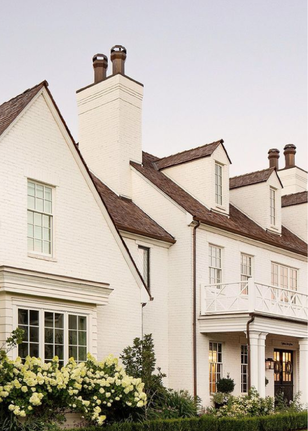Traditional style white brick painted house exterior with dormers and timeless style by The Fox Group. #houseexteriors #whitebrick #whitehouses