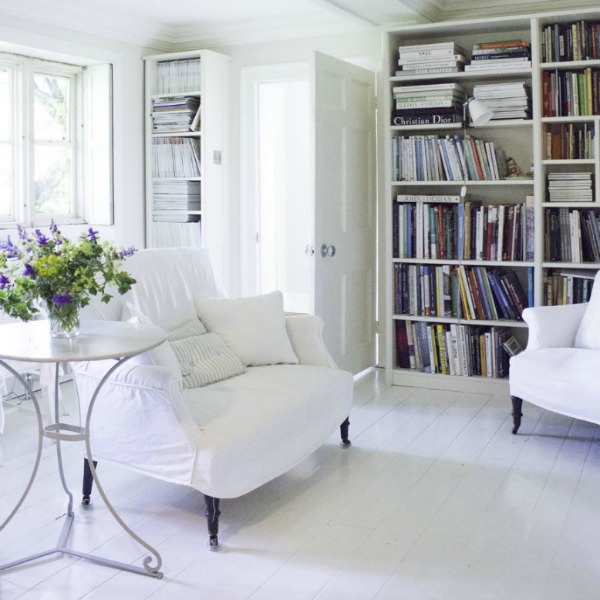 Bookshelves in living room. Charming white Scandinavian style cottage interiors in a property called the Hatch (Beach Studios) near London. #scandinavianstyle #cottage #interiordesign #whitedecor