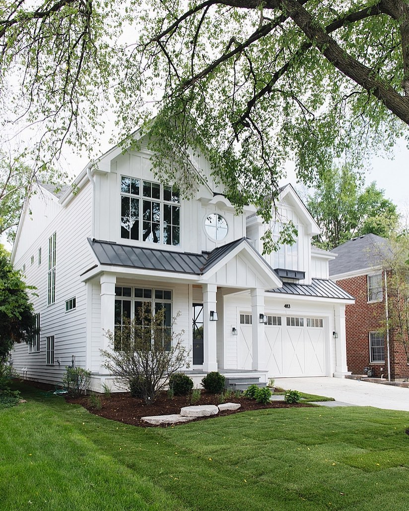 Charming white traditional home by M House Development. Paint color is Farrow & Ball All White. Charming inspiration if you love white painted house exteriors! #whitehouses #housedesign #exteriors #farrowandballallwhite