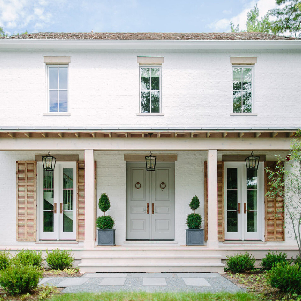 Gorgeous white painted brick exterior on a traditional farmhouse with design by Kate Marker in Barrington, IL. #whitebrick #houseexteriors #katemarker