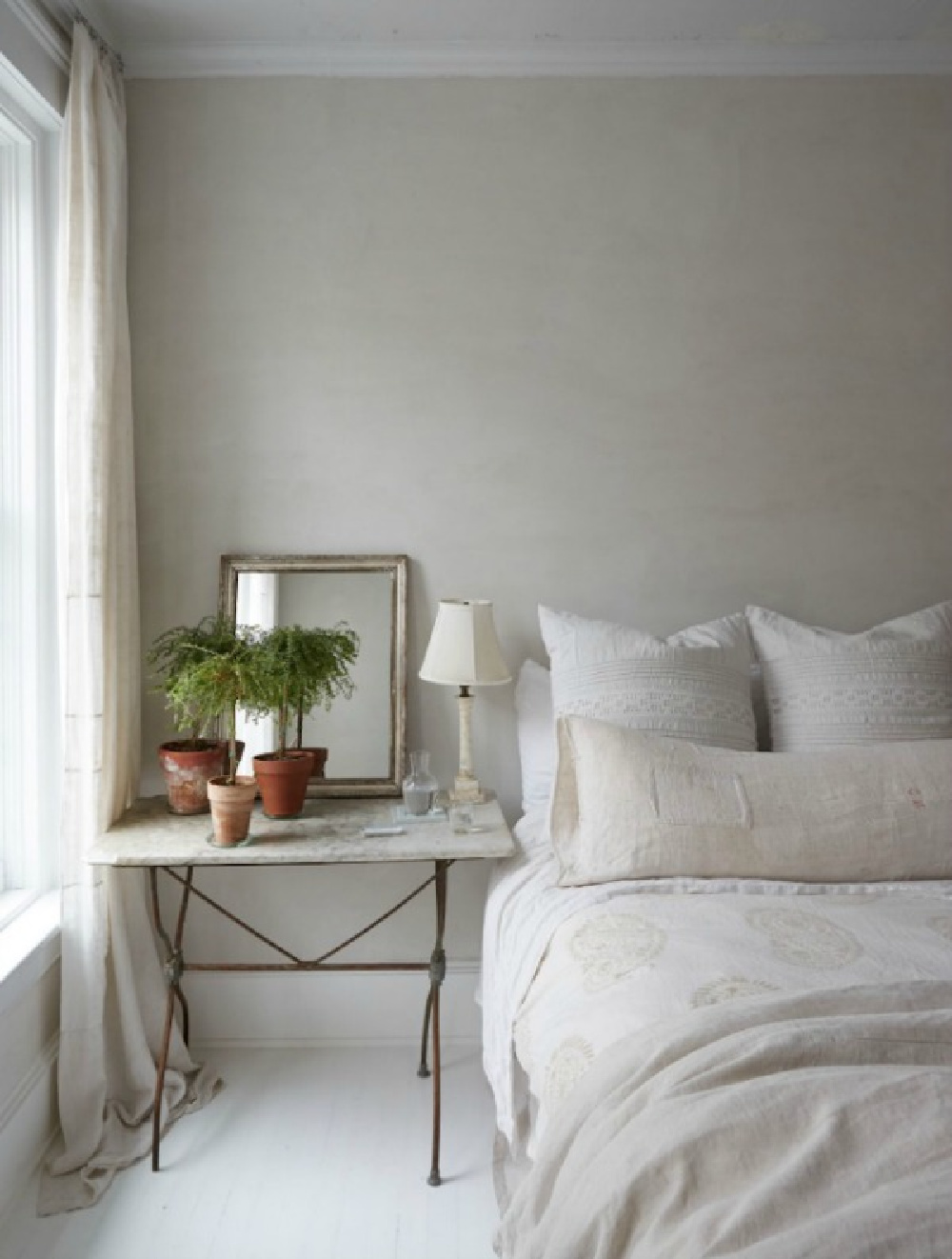 Serene bedroom with European rustic elegance looks as though it might be in the South of France, not New York...see more lovely examples of European farmhouse decor you can bring to your own spaces at home. #Europeanfarmhouse #elegantdecor #countrystyle