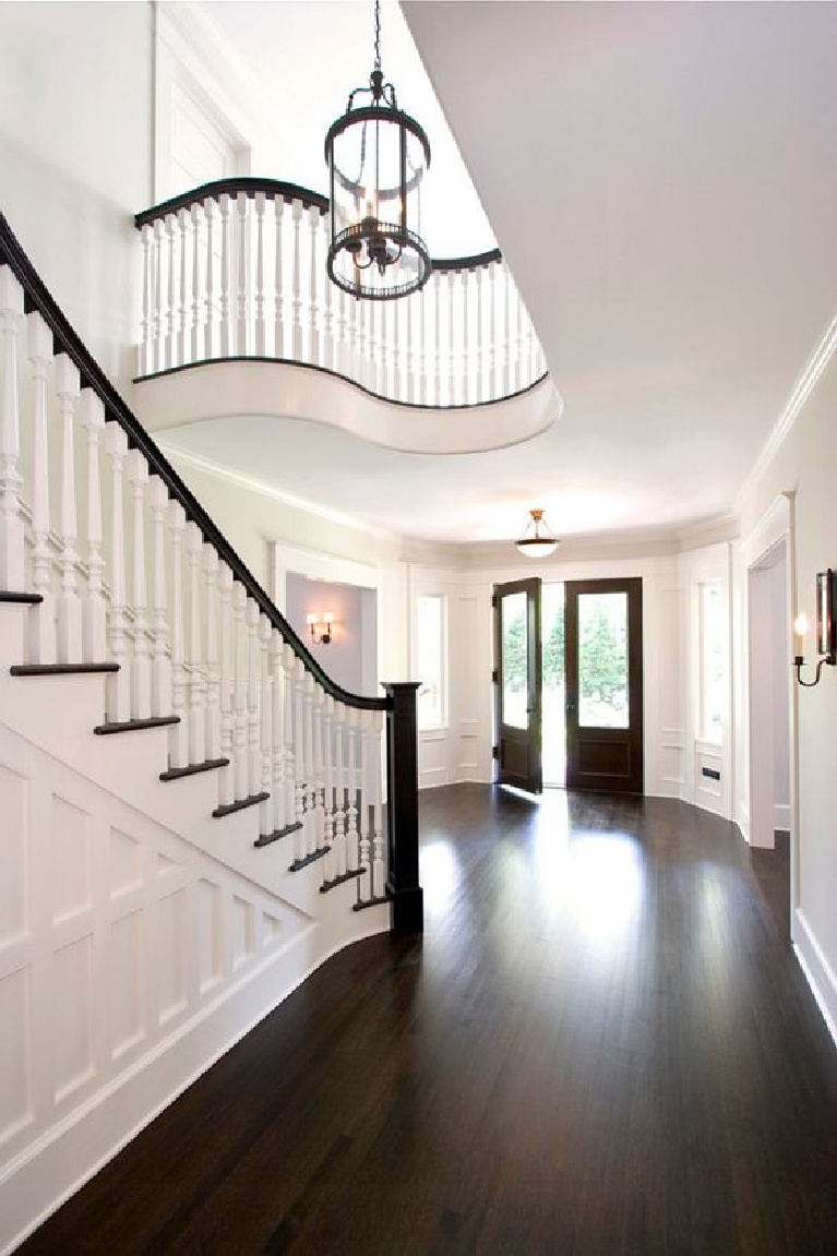 Benjamin Moore Atrium White paint color on walls of an elegant French country entry with staircase. #atriumwhite #benjaminmooreatriumwhite #paintcolors