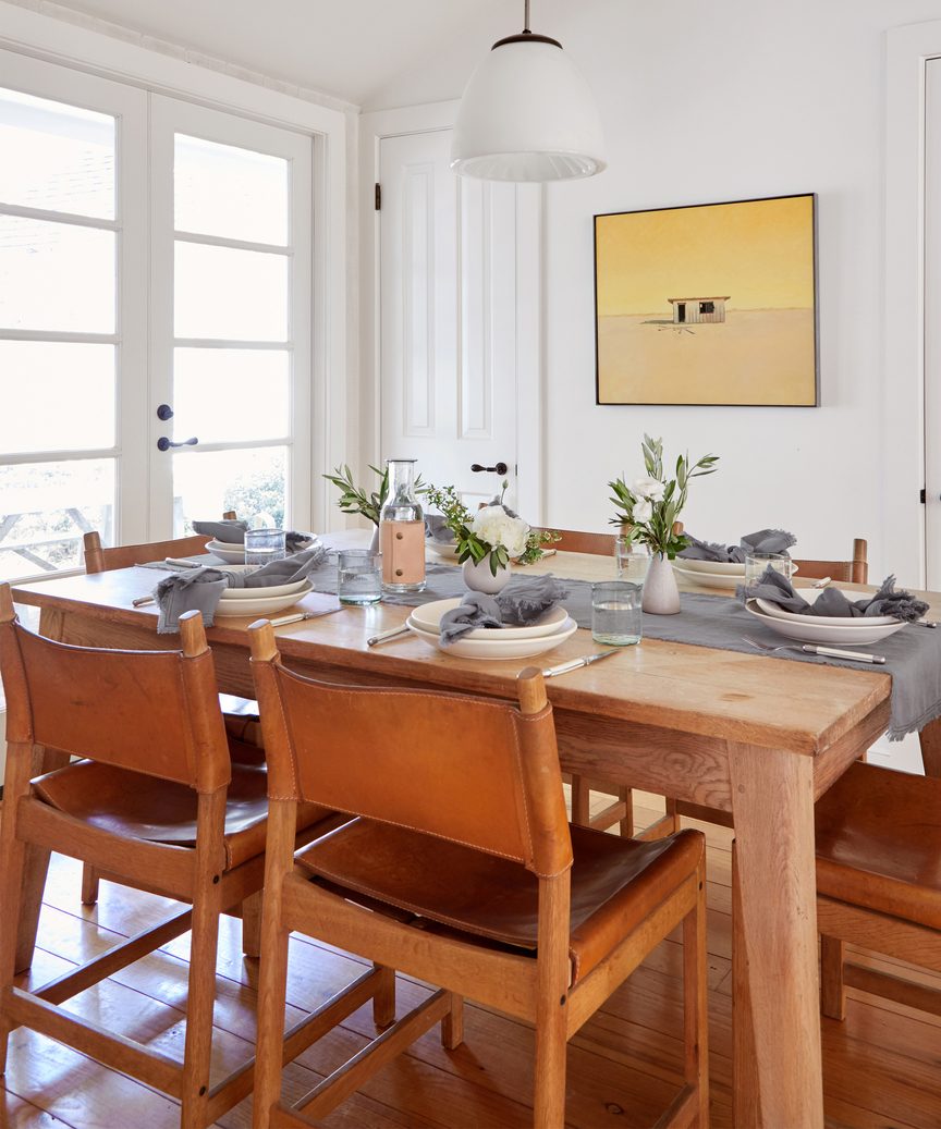 Jenni Kayne frayed linen runner on a minimal design dining table.