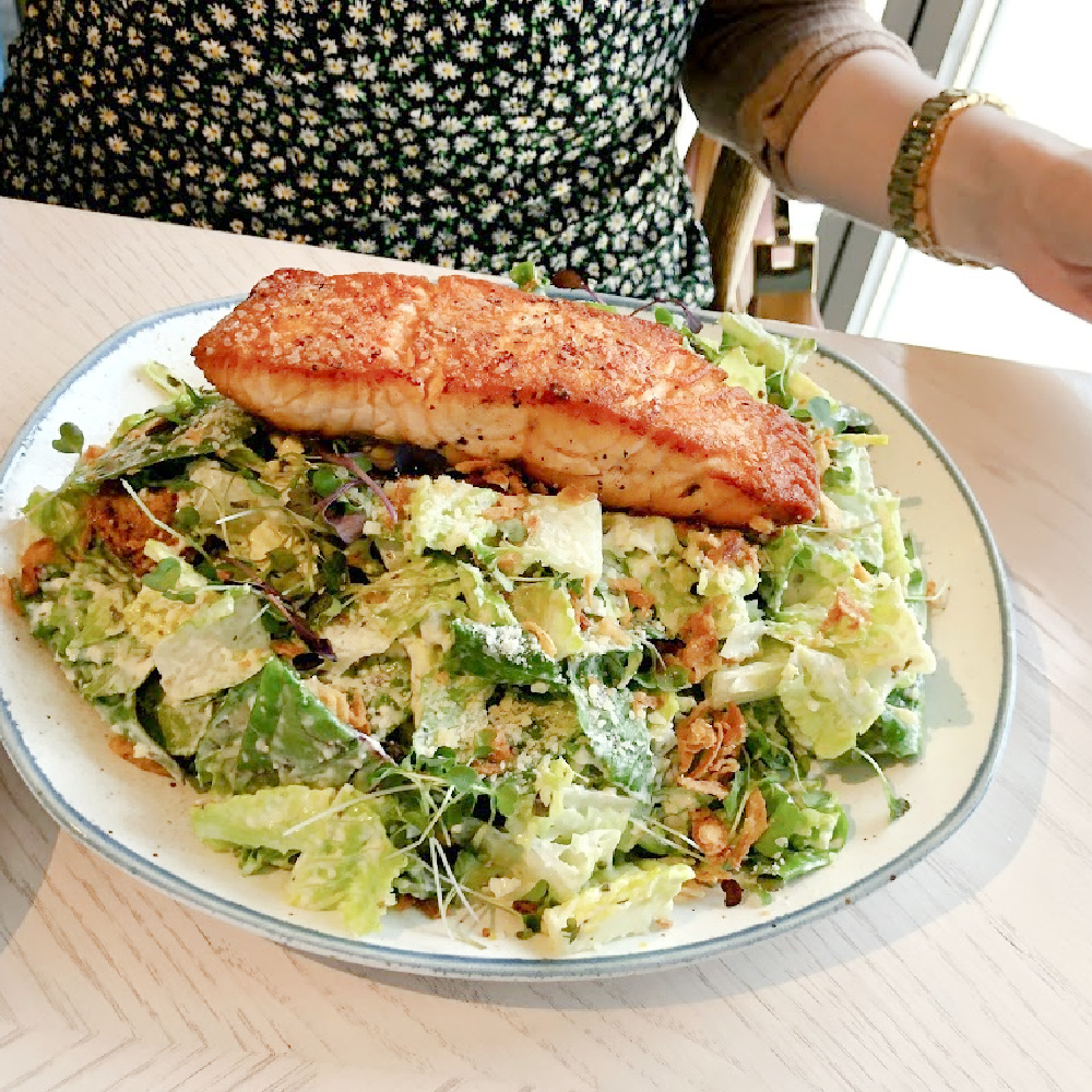Caesar salad with salmon at Hampton Social in South Barrington - Hello Lovely Studio. #hamptonsocial #caesarsalad #thehamptonsocial #brunchfood