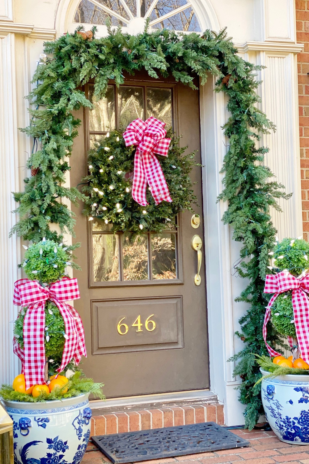 https://www.hellolovelystudio.com/wp-content/uploads/2022/12/pinkclutchblog-pink-christmas-check-ribbon-garland-blue-porcelain-topiaries-porch.jpg