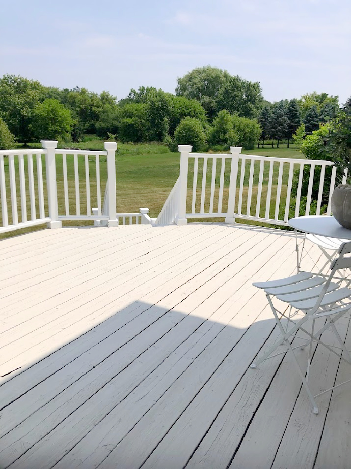 Deck with stone/grey and white railing at the Georgian - Hello Lovely Studio.