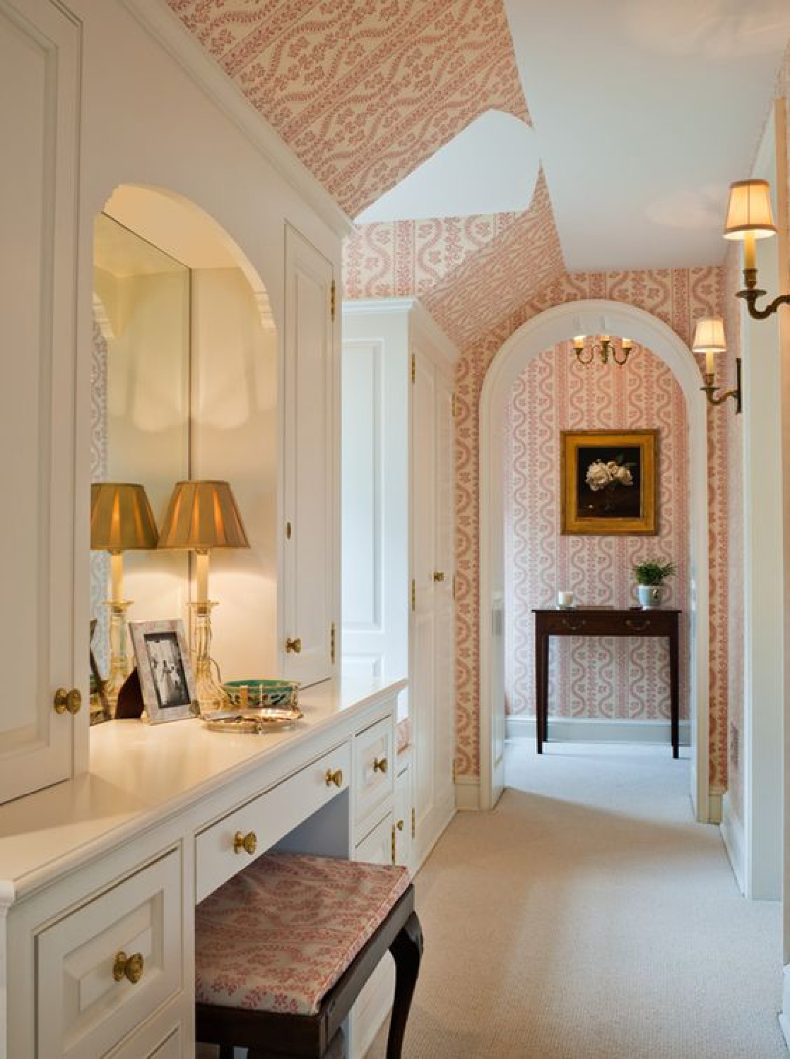 Wondrous and cozy, this romantic timeless bath (Meg Braff) has an enviable makeup vanity, sconces, and rosy pink wallpaper. #cozybathroom #timelessinteriors