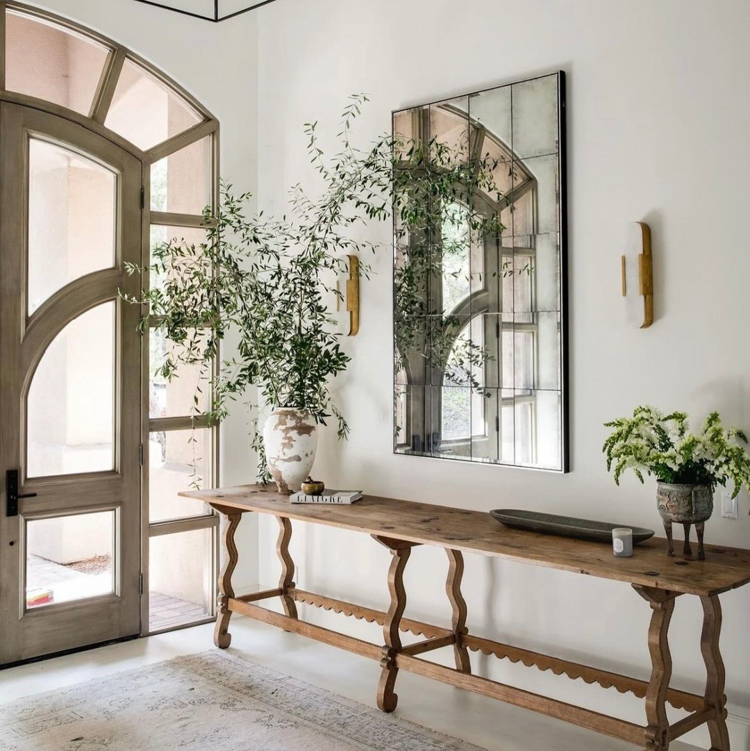 Beautiful earthy vintage modern entry with unique arched door and console table - @hadleyjameshome. 