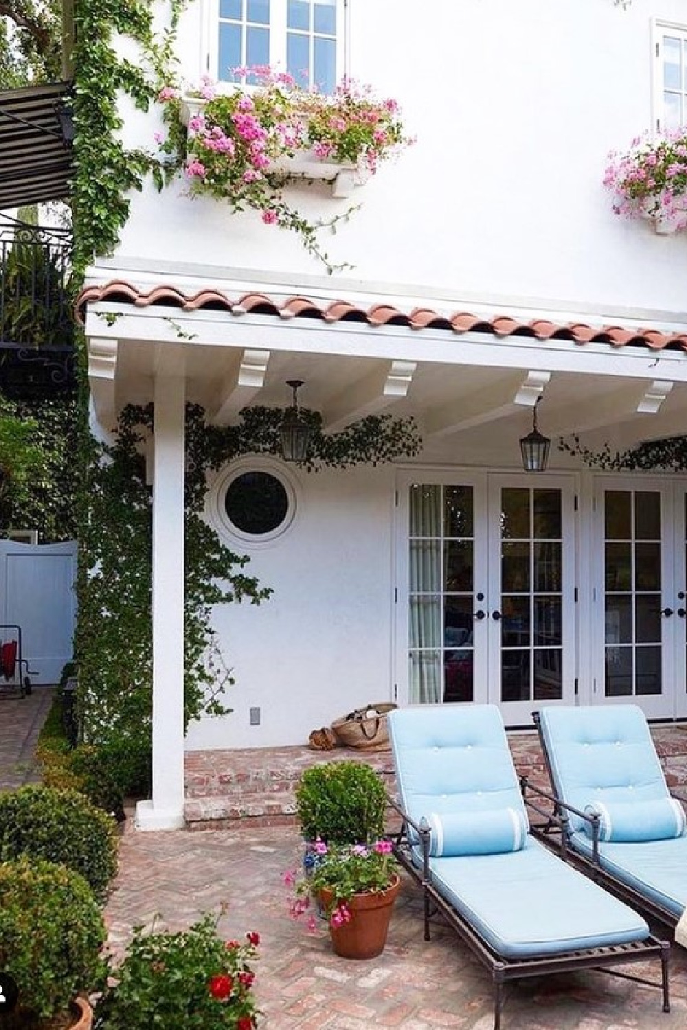 Chaises on a brick patio in summer - @markdsikes.