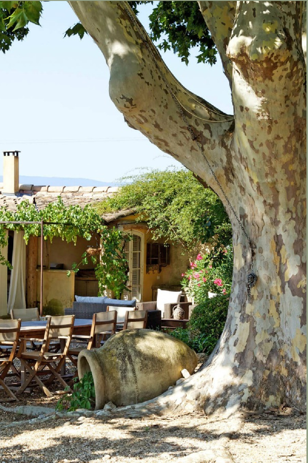 French country courtyard at Provence farmhouse Bonnieux Villa vacation rental from Your Haven In Paris. Romantic Old World rustic elegant interiors and enchanting South of France gardens.