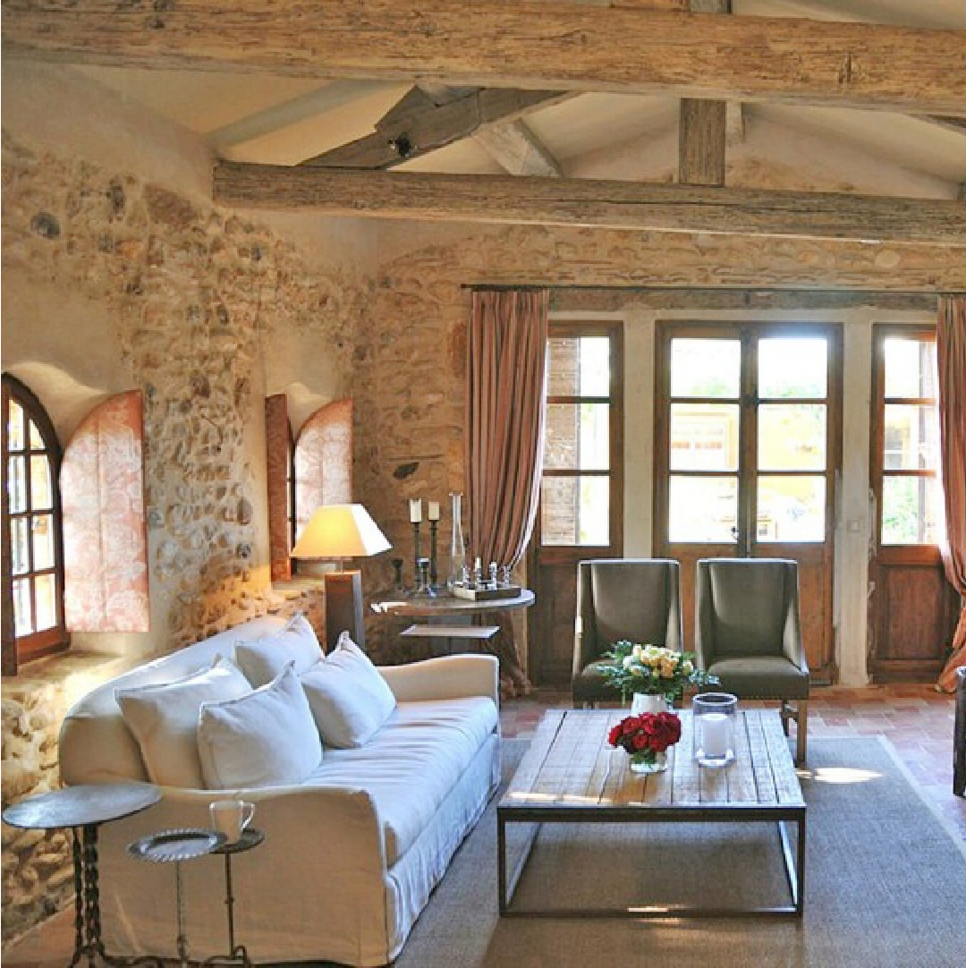 Old World style living room with stone walls, arched windows, shutters, and charming French country charm - Bonnieux villa in Provence (Your Haven in Paris).