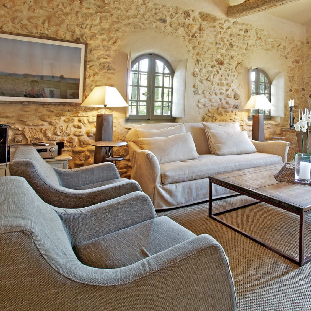 Old World style living room with stone walls, arched windows, shutters, and charming French country charm - Bonnieux villa in Provence (Your Haven in Paris).