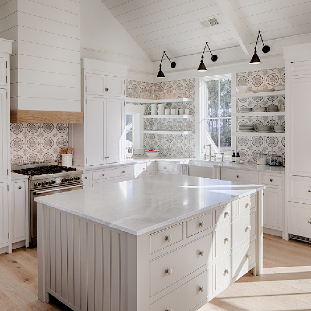 Light grey kitchen island and white Shaker style cabinets with shiplap in a coastal kitchen by Lisa Furey Interiors.