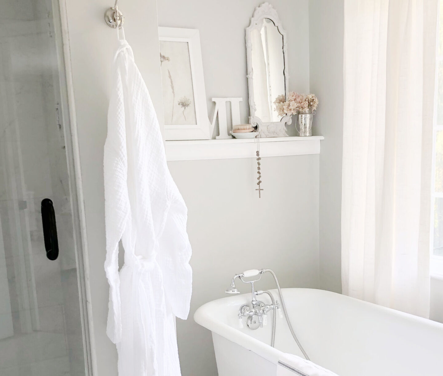 Hello Lovely's serene modern French bathrom with clawfoot tub, white muslin robe (Loom.ist from AWAREHOUSESHOP), and SW Repose Gray walls. #serenedecor #sherwinwilliamsreposegray