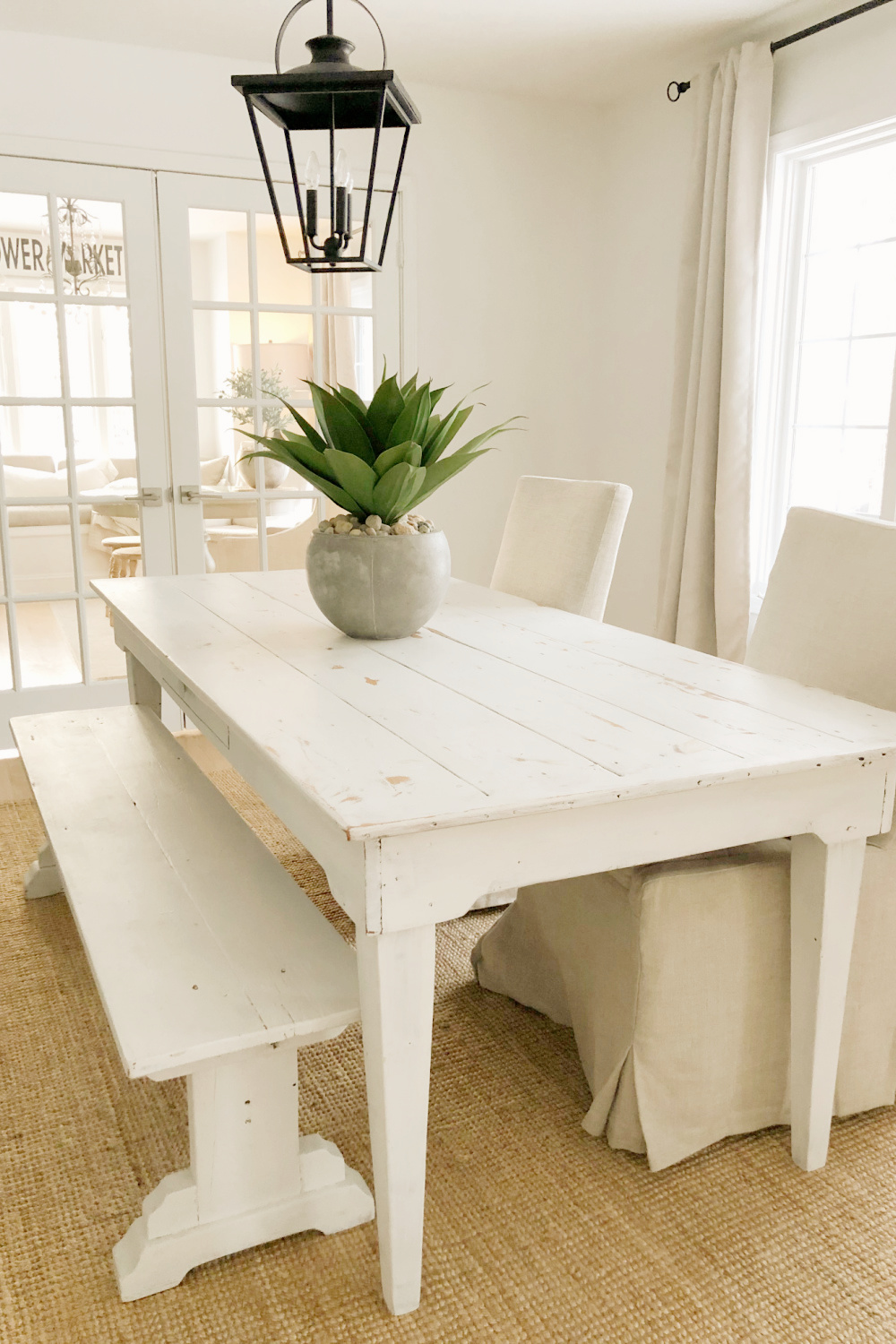 BM White OC-151 on walls in minimal modern rustic dining room with white harvest table and agave in pot - Hello Lovely Studio. #benjaminmoorewhiteoc151