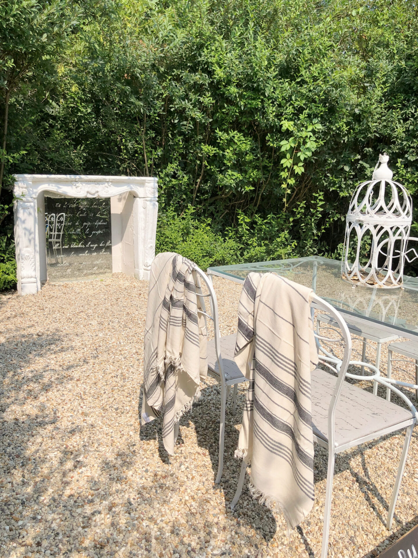 French courtyard with fireplace surround and vintage dining set - Hello Lovely Studio.