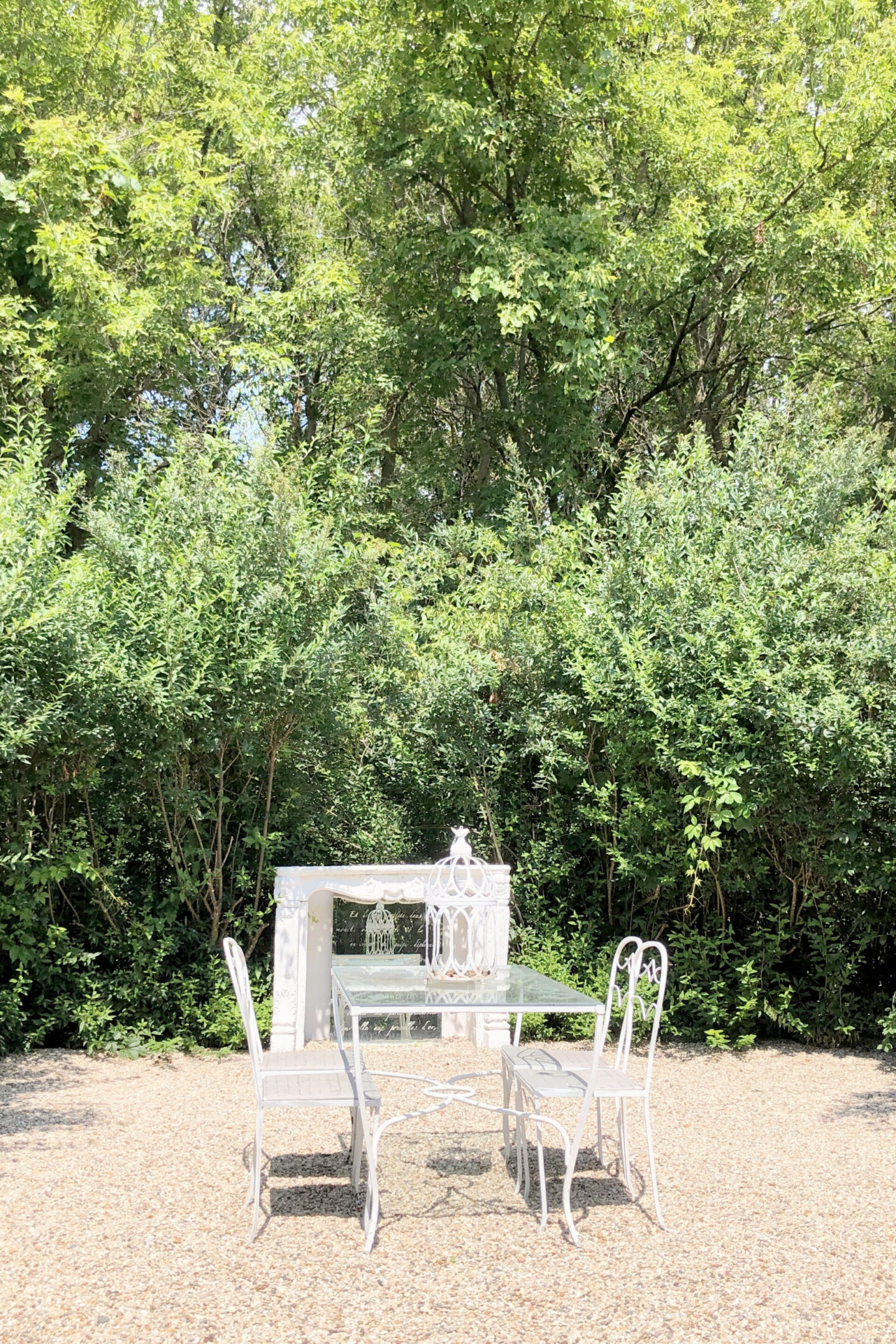 French courtyard with fireplace surround and vintage dining set - Hello Lovely Studio.