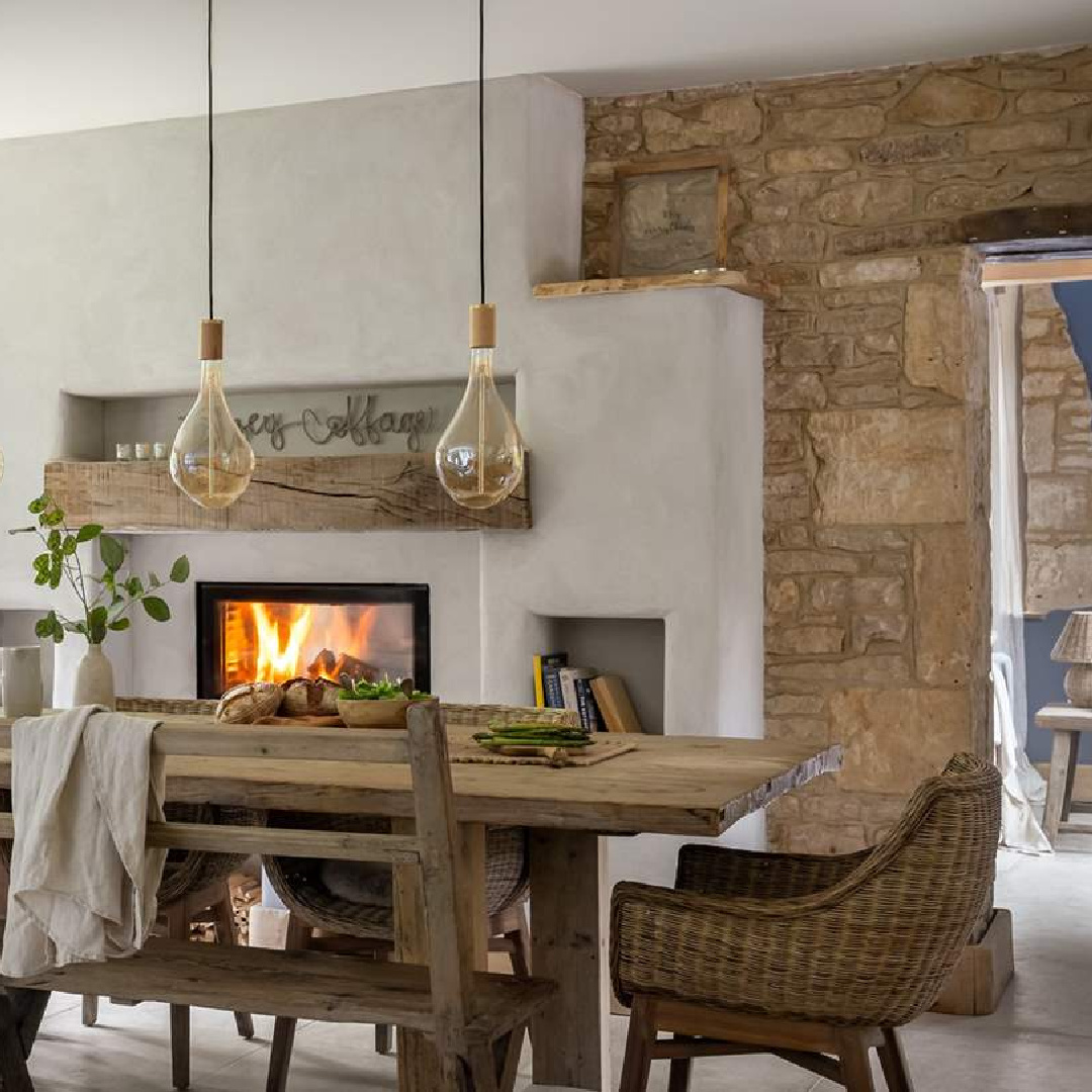 Dining area with fireplace at Amoretta - luxury Cotswolds cottage in Stow-on-the-Wold with rustic elegant interiors and stone - offered by Boutique Retreats in the UK. #cotswoldscottage