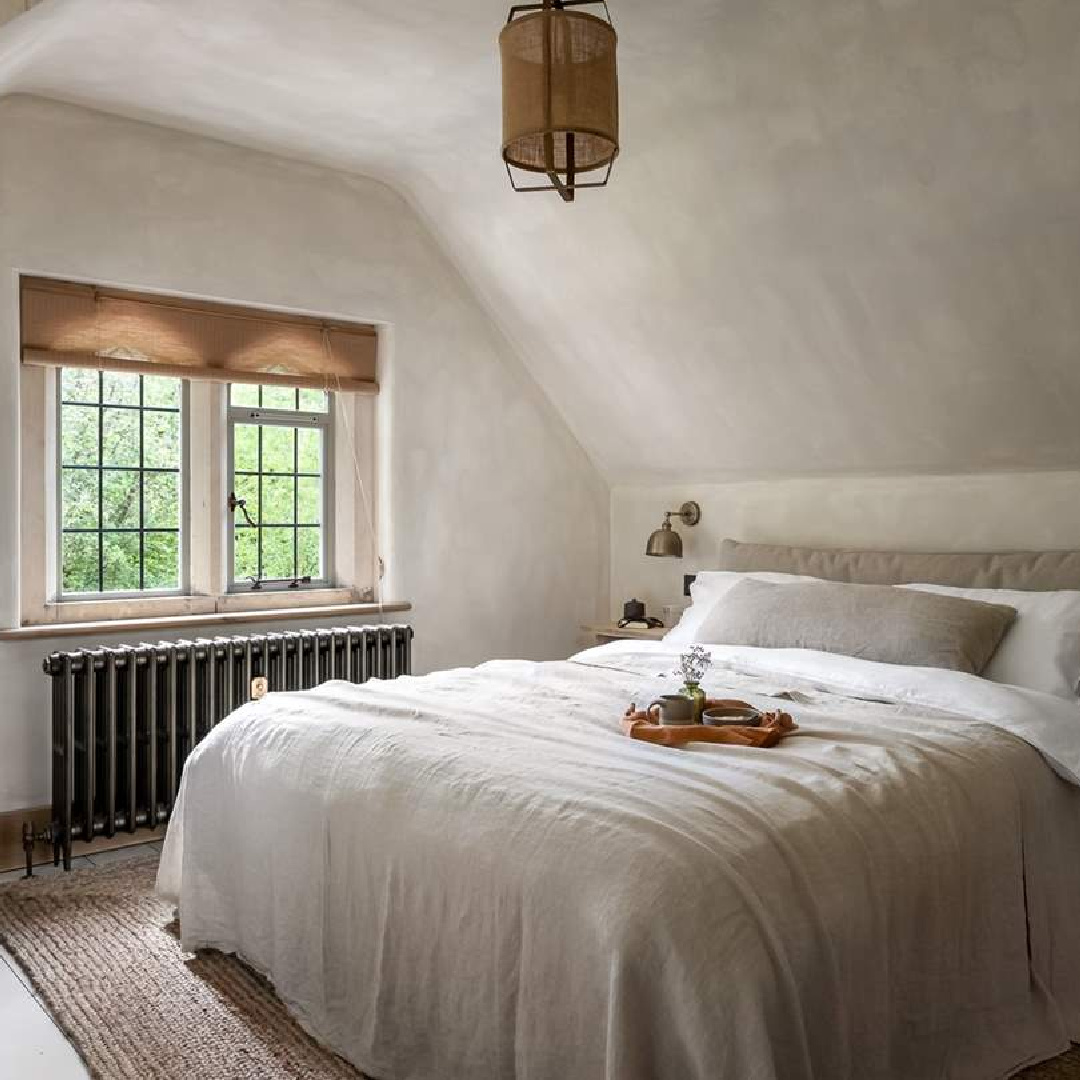 Bedroom with neutral linen at Amoretta - luxury Cotswolds cottage in Stow-on-the-Wold with rustic elegant interiors and stone - offered by Boutique Retreats in the UK. #cotswoldscottage