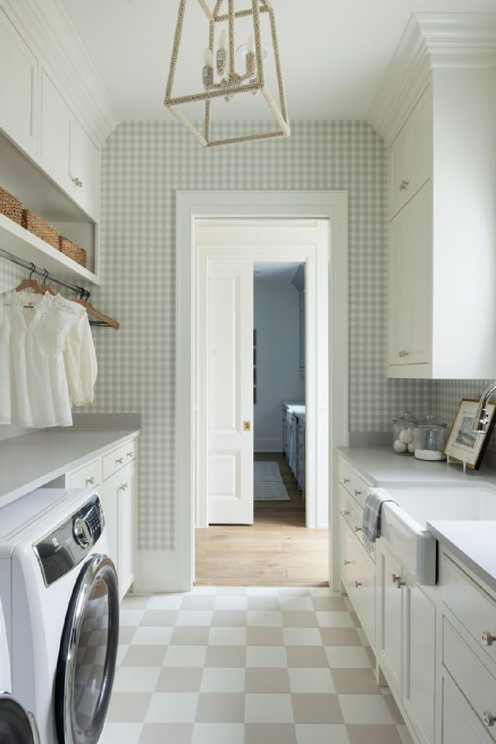 Checkered floor tile, white cabinets, and gingham wallpaper in a lovely laundry room by Bria Hammel Interiors. #cuterooms #checkeredfloor #dreamhousedecor