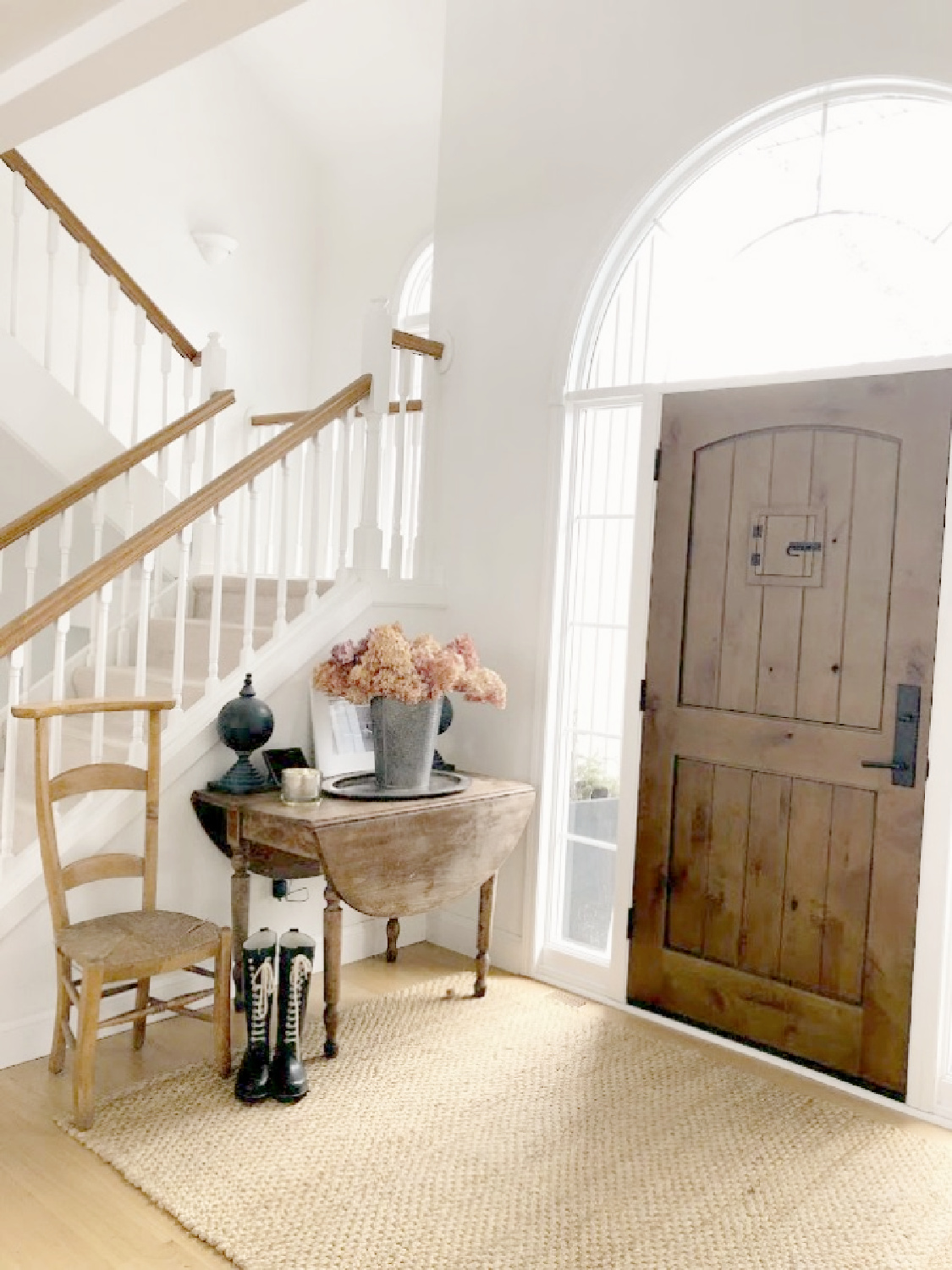 Hello Lovely Studio's renovated modern rustic foyer with knotty alder door and antique dropleaf table. #modernrustic