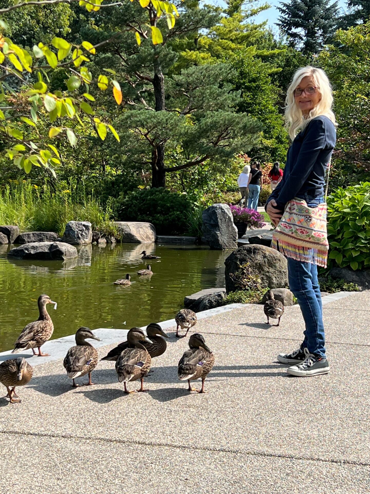 Michele with ducks at Japanese garden pond in late summer - Hello Lovely Studio.