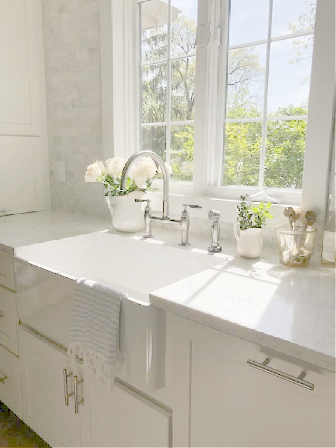 Hello Lovely white Shaker kitchen with Viatera Minuet counters and polished venatino marble subway tile backsplash at farm sink.