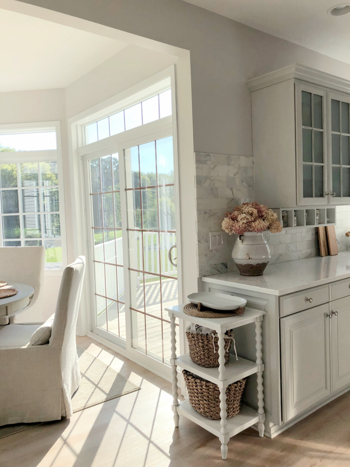 Serene white and light grey European country kitchen with Viatera Muse quartz counters, calacatta gold backsplash, and Pavilion Gray painted cabinets - Hello Lovely Studio. #eiderwhite #modernfrench #europeancountry #viateramuse