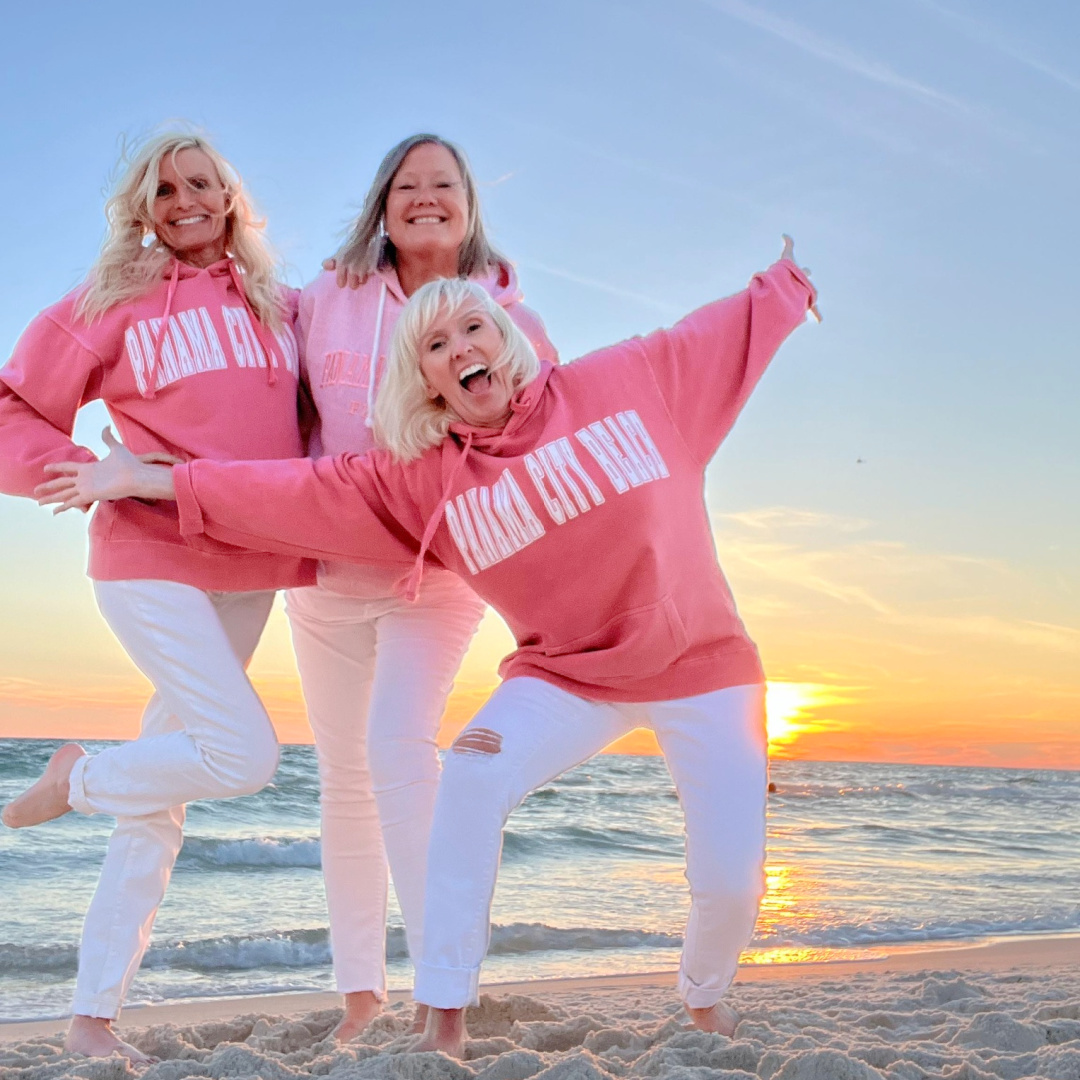 Michele and friends on beach at sunset in pink sweatshirts - Hello Lovely Studio.