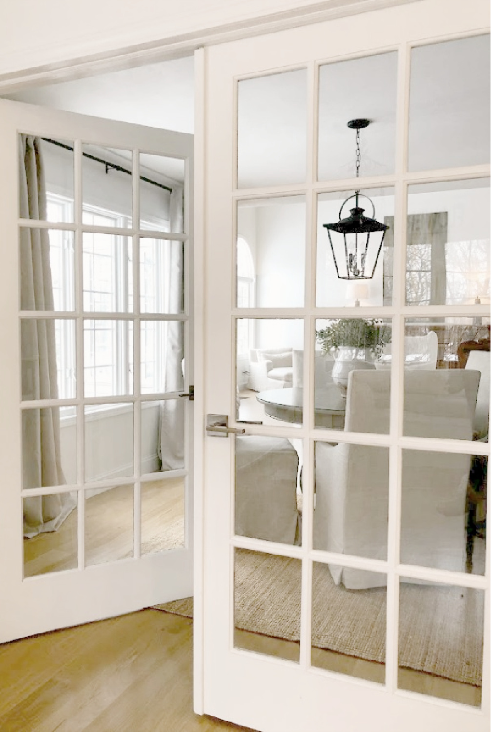 French doors between breakfast room and dining room in Hello Lovely's modern European country renovated home.