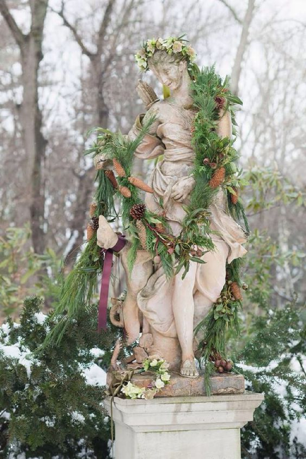 Statue decked out in greenery for the holidays - Melissa Hammond. #frenchcountrychristmas #frenchchristmas