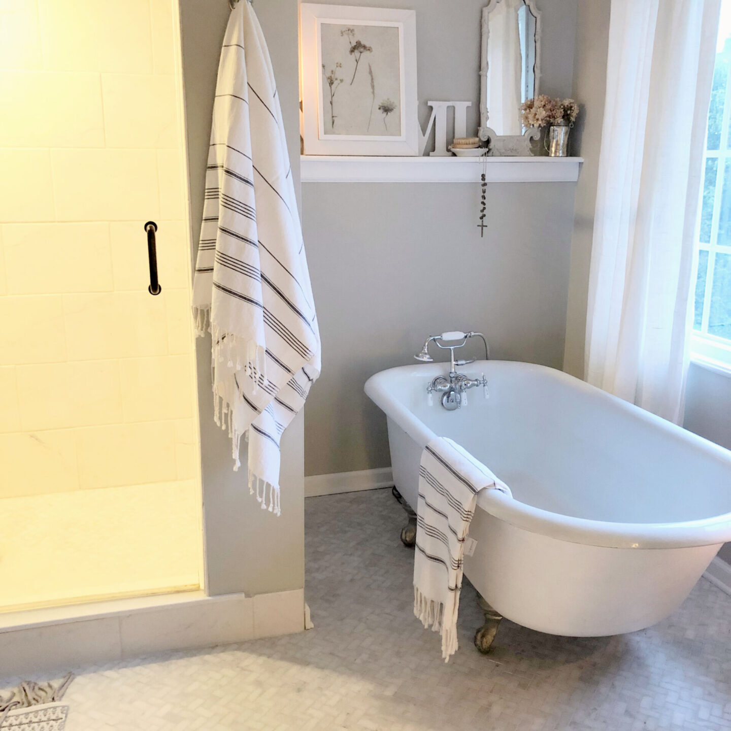 Hello Lovely's DIY renovated classic white bath with clawfoot tub and marble herringbone tile floor. Sherwin-Williams Repose Gray on walls. #sherwinwilliamsreposegray