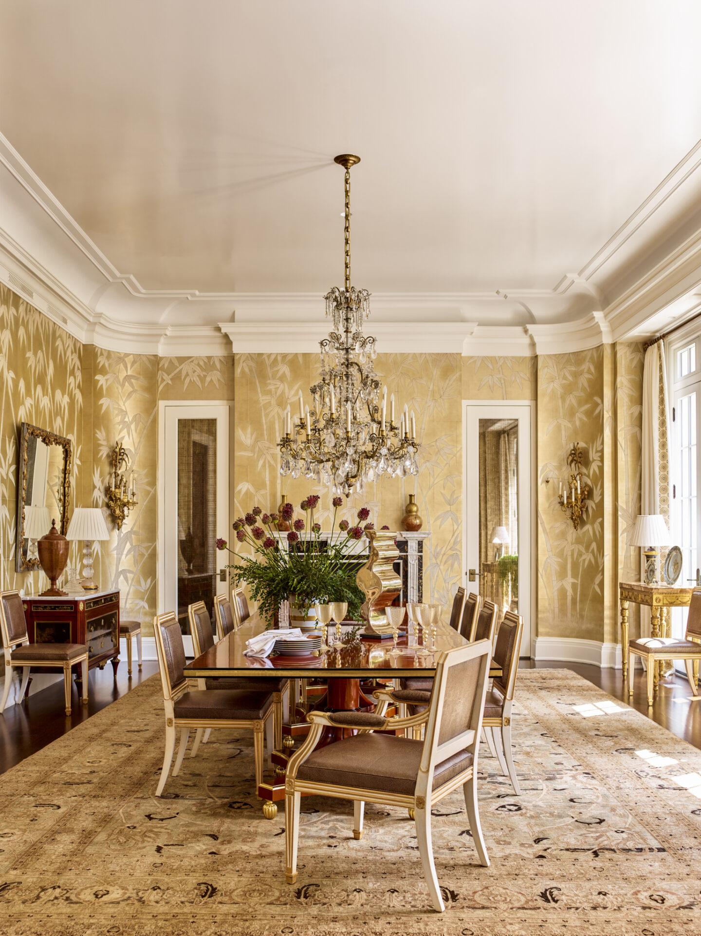 Elegant dining room with handpainted yellow wallpaper in CULLMAN & KRAVIS INTERIORS Lee Cavanaugh, Sarah Ramsey, Alyssa Urban (Rizzoli, 2024).