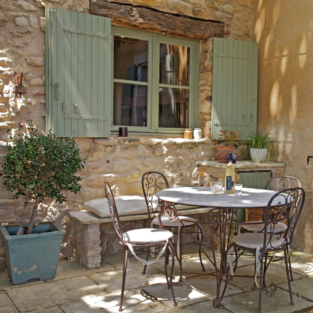 French green shutters on stone country farmhouse in Provence with Old World style gardens and rustic dining - Bonnieux Villa (Your Haven in Paris).