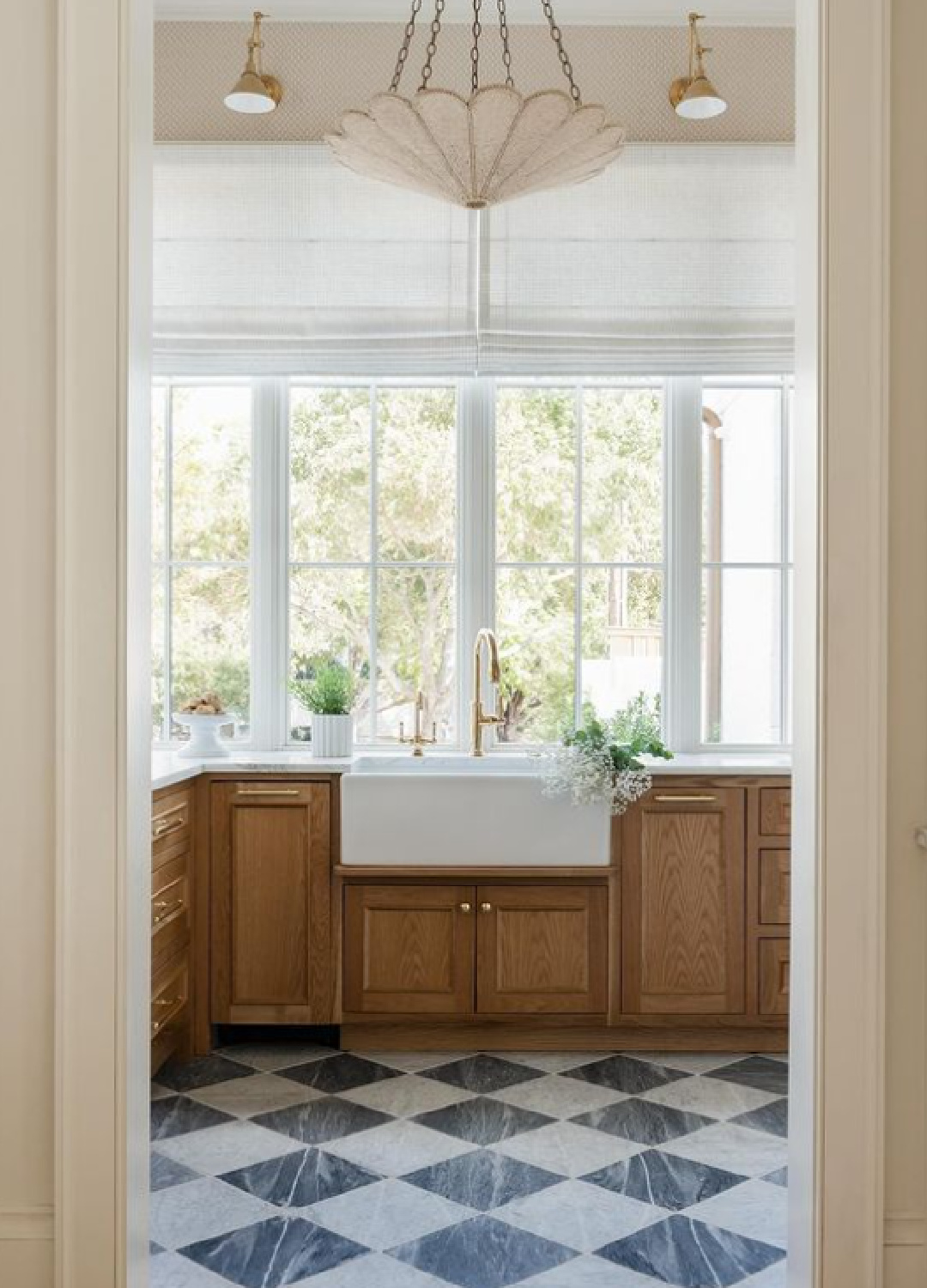 Light filled prep area with farm sink and checkered floor - Kate Marker Interiors.