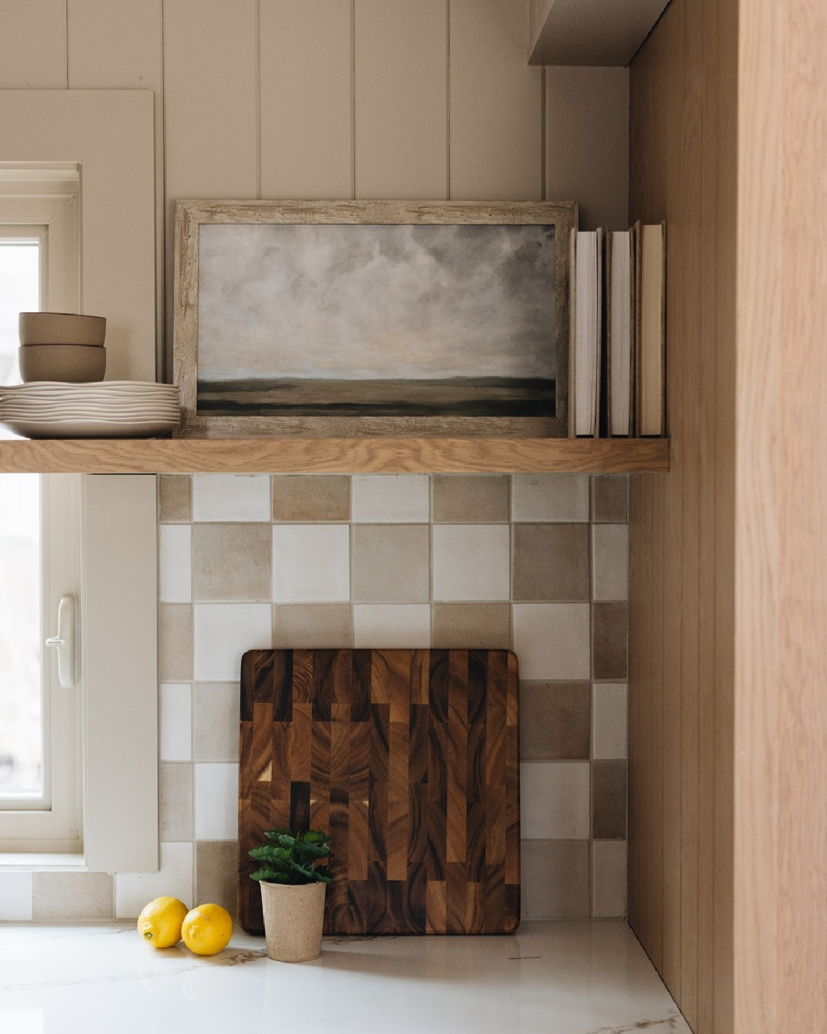 Kate Marker Interiors designed checkered backsplash and floating shelf in charming bespoke kitchen - @StofferPhotographyInteriors.