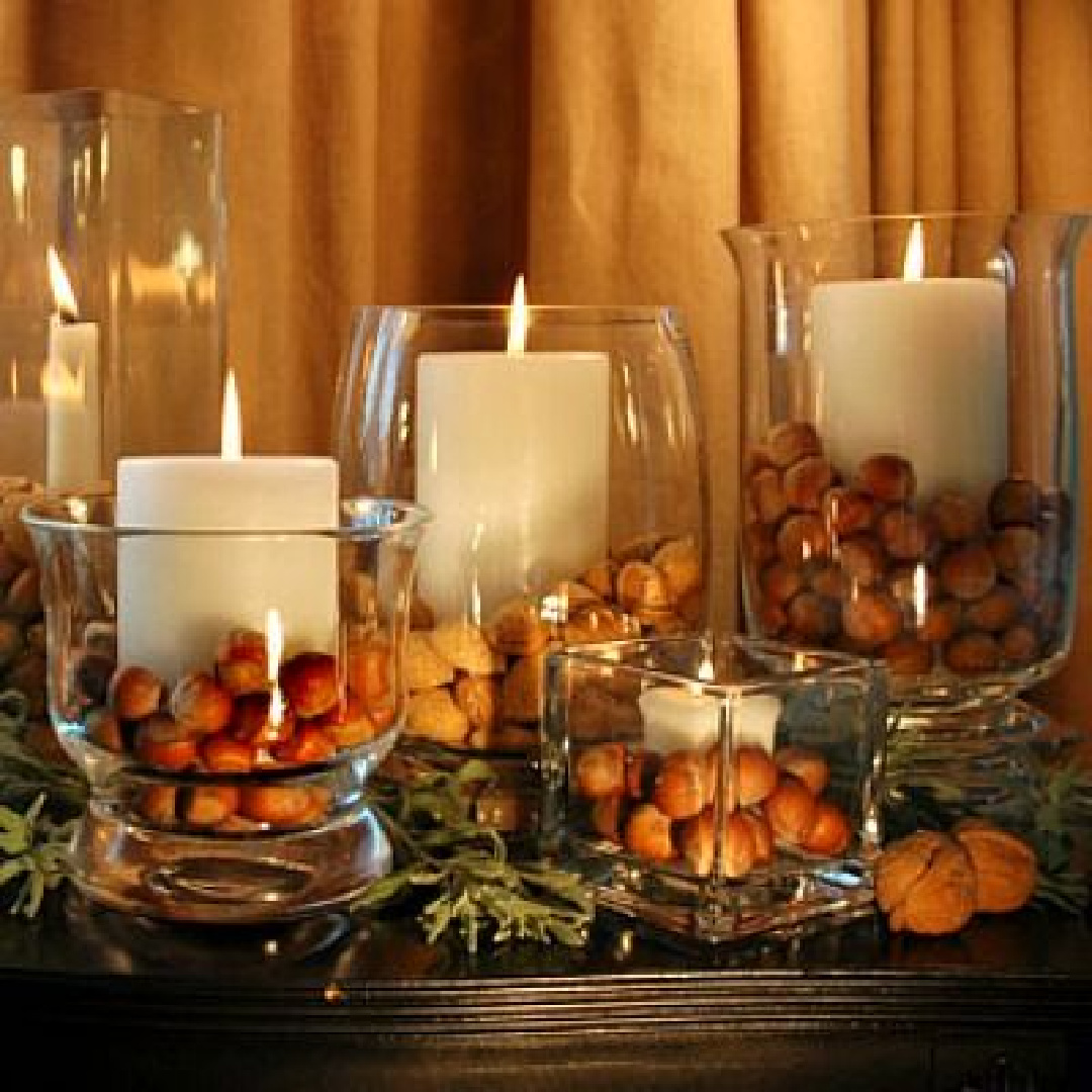 Simple fall or holiday tablescape decor idea with chestnuts and candles in clear glass - Rosemary-Thyme. #falltablescapes