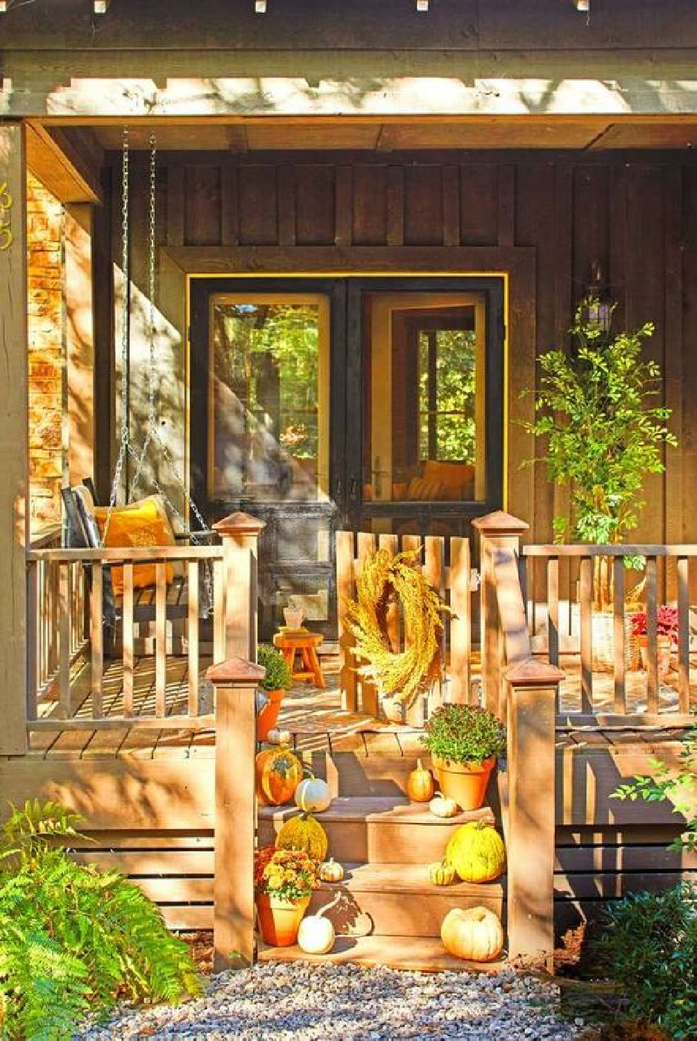 Beautiful dappled natural light on a fall front porch with rustic style - Southern Living. #fallporch #rusticfalldecor