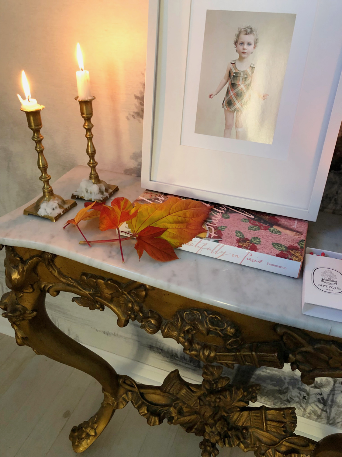 Hello Lovely's entry in Fall with colorful leaves on a French console with candles. #modernfrench #hellolovely #fallentry