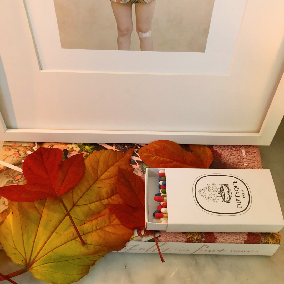 Hello Lovely's entry in Fall with colorful leaves on a French console with candles. #modernfrench #hellolovely #fallentry